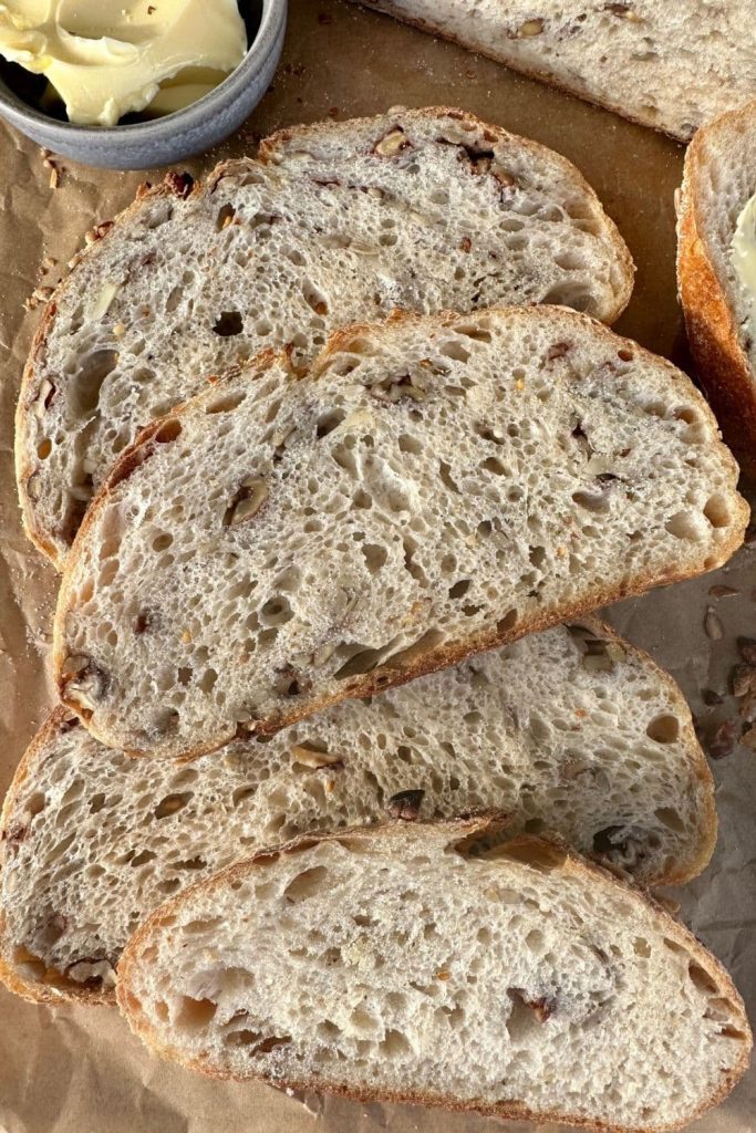 Several slices of high protein sourdough bread laid out on a piece of parchment paper.