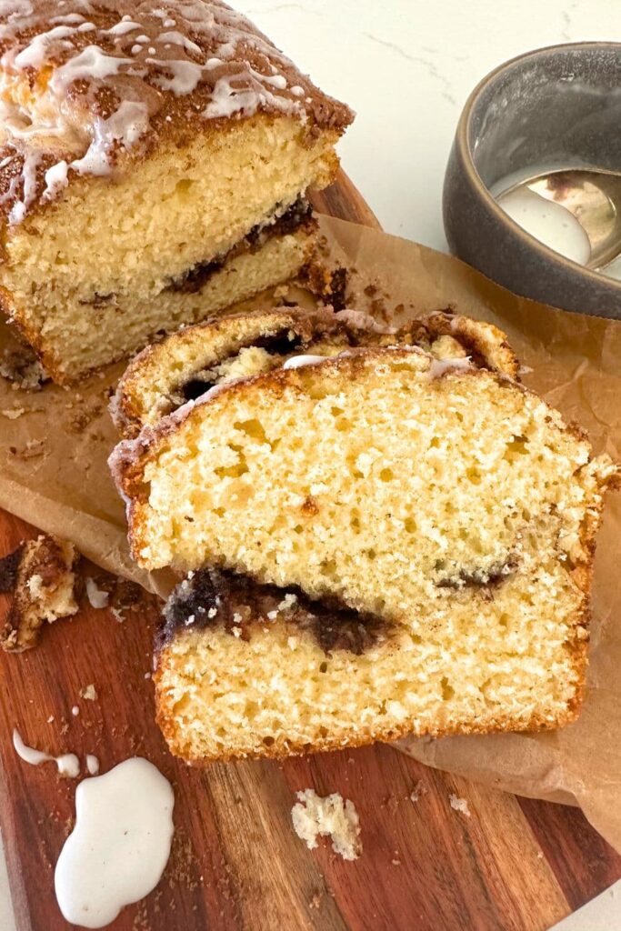 A close up photo of a slice of sourdough discard cinnamon ripple quick bread.