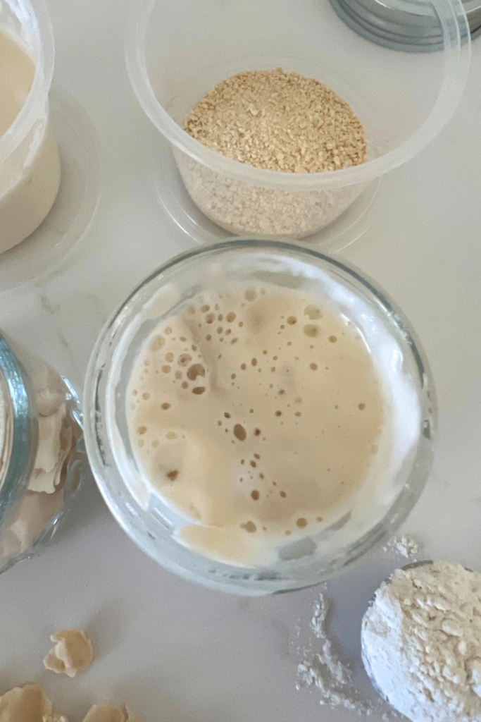 Overhead of sourdough starter in a glass jar.