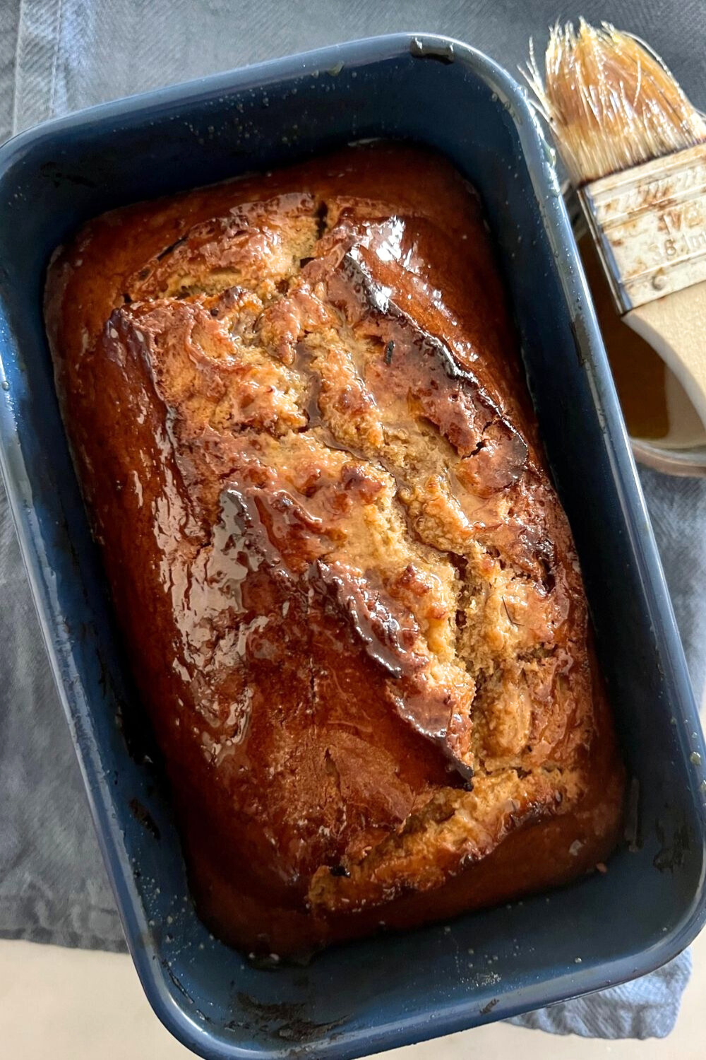 Loaf of sweet sourdough banana bread in a loaf pan.